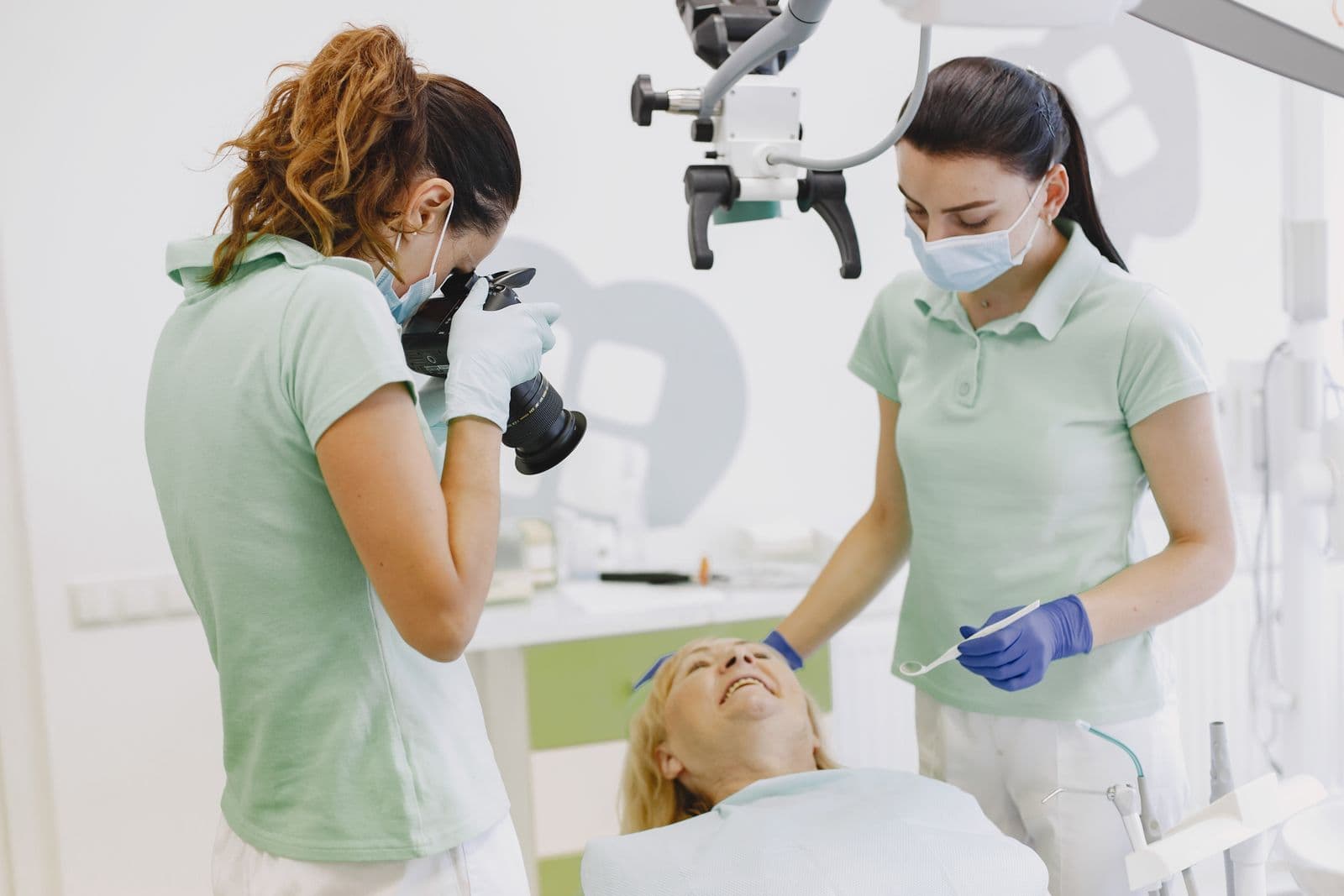 Dentist and assistant treating a patient in a modern clinic
