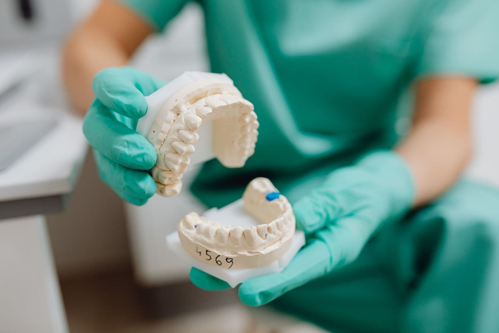 Dentist holding a dental cast of a full arch