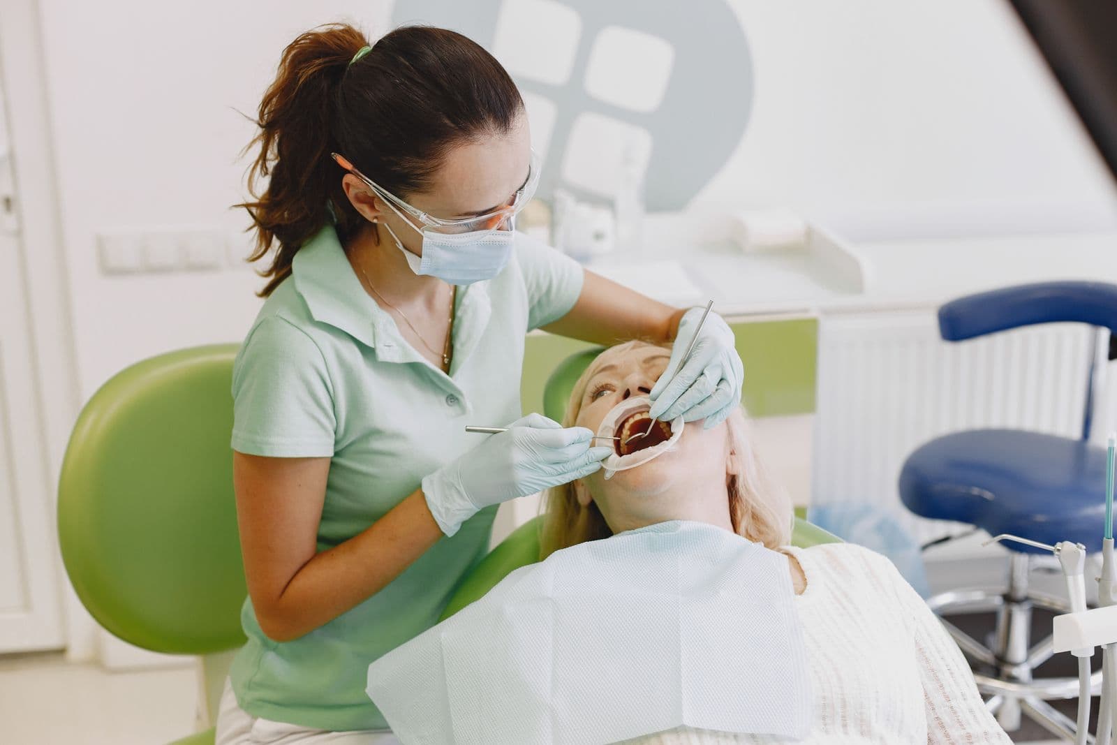Dentist examining a patient's teeth at a routine visit